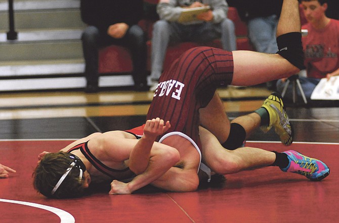 Cole Baumgartner of Jefferson City prepares to pin Keegan Loyd of Joplin during their 126-pound match Friday in the Class 4 District 3 Tournament at Fleming Fieldhouse. 