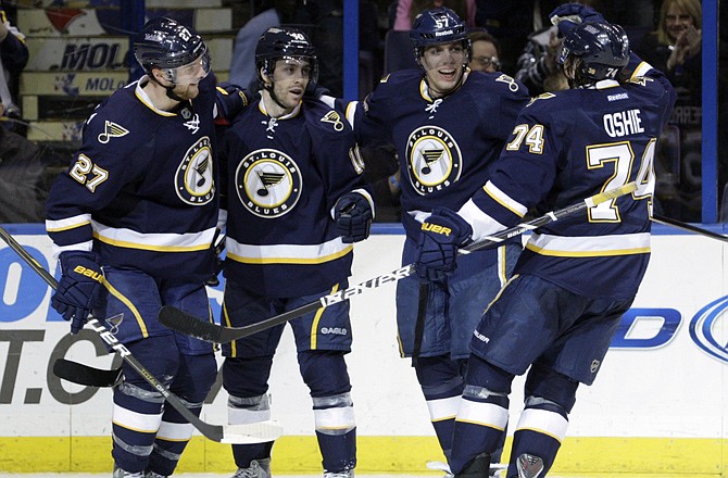 St. Louis' David Perron, second from right, celebrates with teammates Alex Pietrangelo (27), Andy McDonald (10) and T.J. Oshie (74) after scoring a goal in the second period of the Blues' 3-0 victory over San Jose on Sunday in St. Louis.