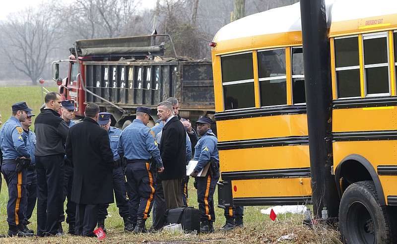 Investigators view the scene of a school bus crash Thursday in Chesterfield, N.J. The bus collided with a dump truck.