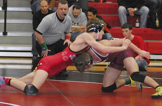 Cole Baumgartner of Jefferson City (left), shown here wrestling Keegan Loyd of Joplin in last weekend's district tournament at Fleming Fieldhouse, will be bidding for his fourth state individual medal at the Class 4 championships. 