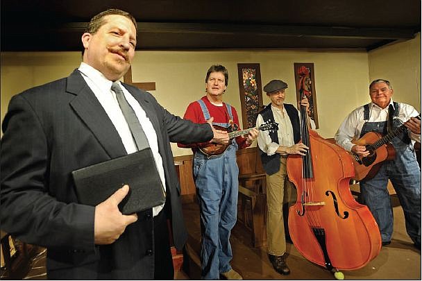 Pastor Mervin Oglethorpe (Mike Landrum) introduces the Sanders Family Band (from left, Dale Wilkes, Mark Howard and Tom Mangan) to the congregation at Mt. Pleasant Baptist Church during rehearsals for Stained Glass Theatre's production of "Smoke On The Mountain."