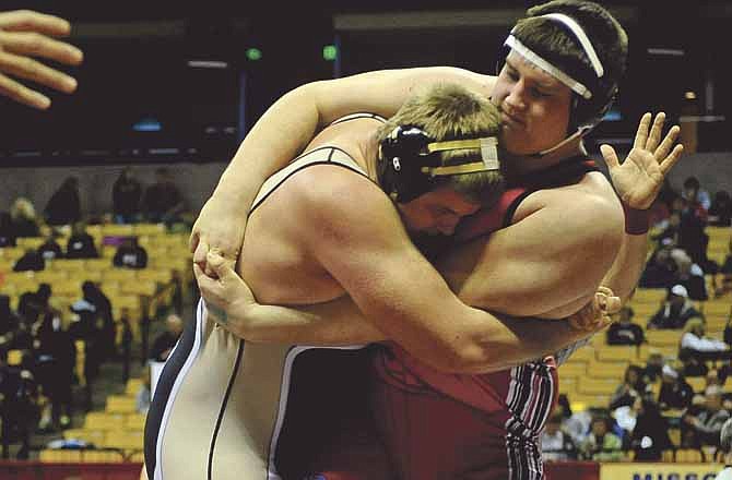 Jefferson City's John Carter locks up with Oakville's James Broderick during Carter's win by fall Thursday at Mizzou Arena.