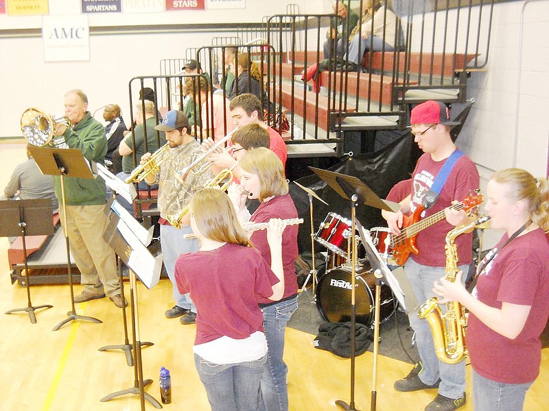 The Parliament Pep Band performs during a William Woods University basketball game. Faculty member Murphy Tetley - who also wrote the school's fight song - formed the group to help boost school spirit at games.