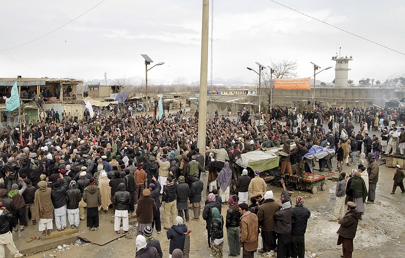 Afghans shout slogans Tuesday in front of the Bagram Air Base during an anti-U.S. demonstration north of Kabul, Afghanistan. More than 2,000 angry Afghans, some firing guns in the air, protested against the improper disposal and burning of Qurans and other Islamic religious materials.