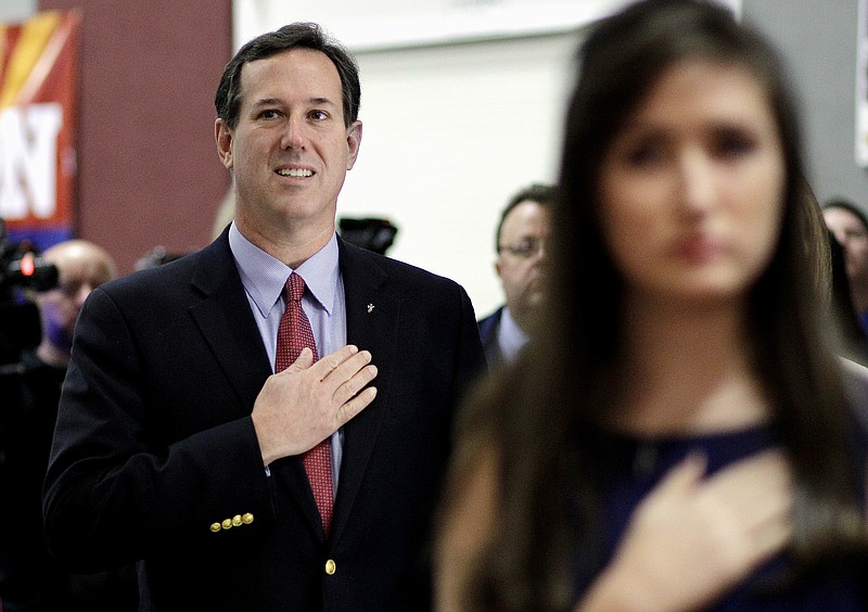 Republican presidential candidate, former Pennsylvania Sen. Rick Santorum, left, says the Pledge of Allegiance during a campaign stop Tuesday at the Maricopa County Lincoln Day Luncheon in Phoenix, Arizona.