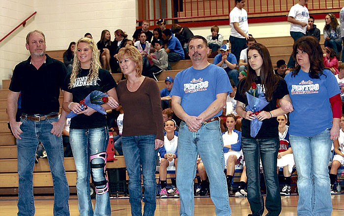 From left are senior Lady Pintos Holly Wolfrum and parents Gail and Janet Wolfrum, and Tanner Roberts and parents Jon and Tammy Roberts.