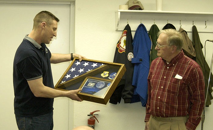 Lt. Col. Mark Pye, left, B2 13th Bomber Squadron commander, presents a shadow box with a flag CRFPD Board Vice President Glen Bayne.