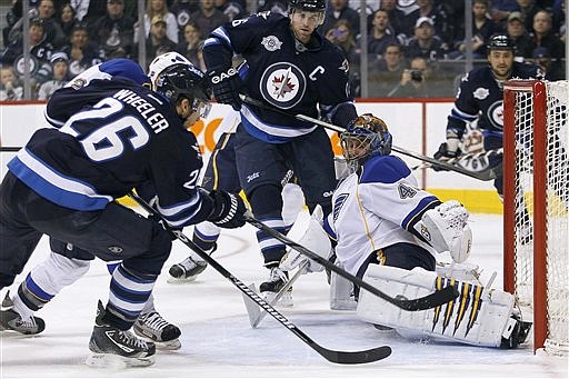 Winnipeg Jets' Blake Wheeler (26) scores past St. Louis Blues' goaltender Jaroslav Halak (41) during second period NHL hockey action in Winnipeg, Manitoba, on Saturday, Feb. 25, 2012. 