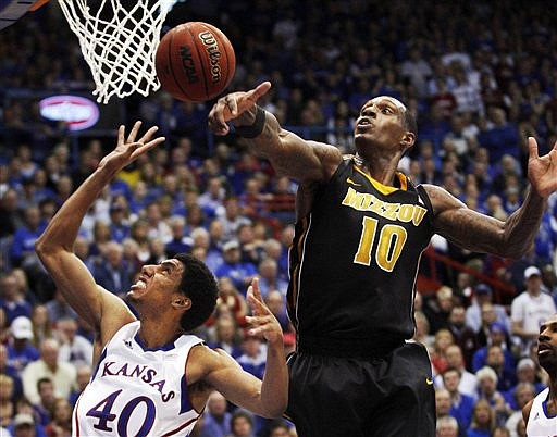 Missouri forward Ricardo Ratliffe (10) blocks a shot by Kansas forward Kevin Young (40) during the first half of an NCAA college basketball game in Lawrence, Kan., Saturday, Feb. 25, 2012.