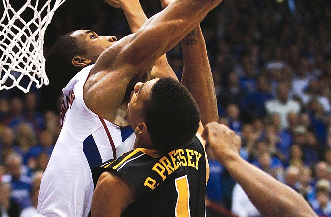 Thomas Robinson of Kansas blocks a shot by Missouri's Phil Pressey at the end of regulation Saturday in Lawrence, Kan.