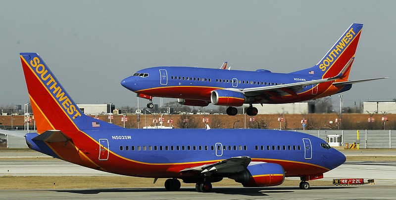 A Southwest Airlines Boeing 737 waits to take off at Chicago's Midway Airport as another lands. Airfares are up and headed higher in summer 2012. Airlines blame soaring fuel prices which could cost them billions more than last year. That means fares, which normally rise as the summer travel season nears, could increase faster than normal.