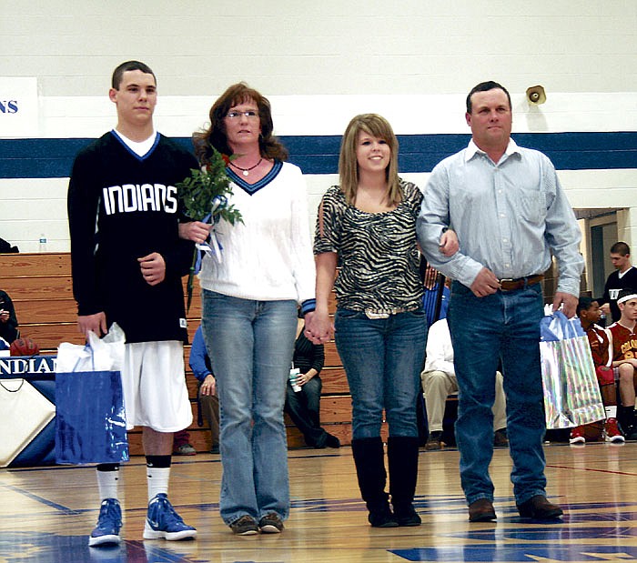 Senior members of the Russellville Indian varsity basketball team were recognized prior to the varsity game on Senior Night Friday at the high school. From left are Alex Barbour and sister Shelby Barbour, team manager for the Indians, and their parents Robin and Melvin Barbour.