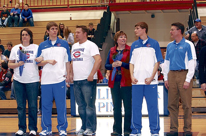 Senior Pinto basketball players and their parents were recognized Feb. 21 prior to the varsity game against Blair Oaks at California High School. From left are Nathanial Caudel with parents Cher and Jeremy Caudel, and Adam Burger with parents Susan and Philip Burger.