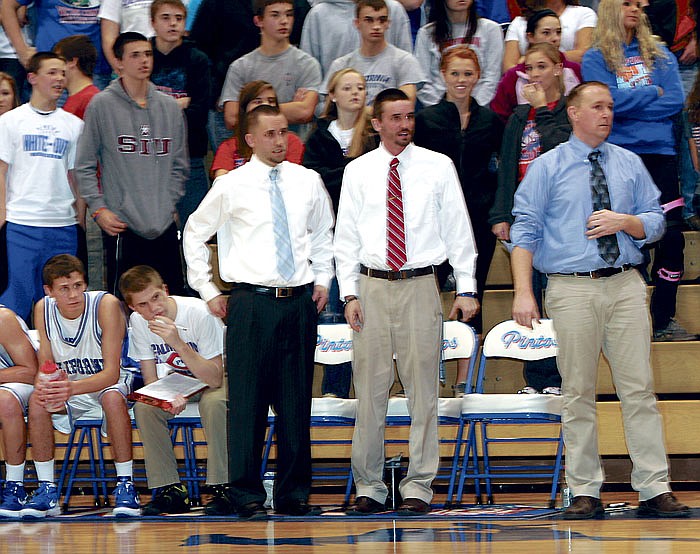 From left, Pinto Head Basketball Coach Blair Scanlon, Freshman Coach Dustin Jeffries and JV Coach Lance Conner, as well as Pinto fans behind them, were on their feet the last three minutes of California's JV game against Blair Oaks Feb. 21 where, after trailing the entire game, the JV Pintos turned up the heat in those final minutes to defeat the Falcons 46-41 and end the season undefeated, 16-0.