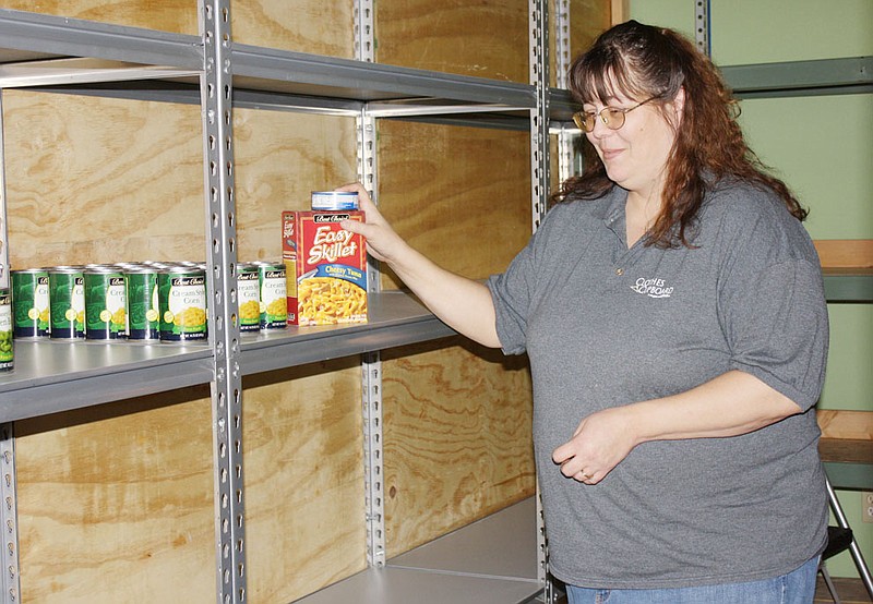 Julie Roark, who manages the SERVE, Inc. food bank in Fulton, surveys the mostly barren food bank shelves on Wednesday afternoon. "The Scouting for Food" drive by local Boy Scouts couldn't come at a better time on Saturday. Right now we have food for only about 15 families," Roark said.