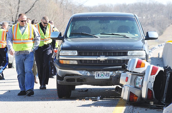 Jefferson City police accident investigators reconstruct the scene of an accident Wednesday on westbound U.S. 50 near Clark Avenue.
