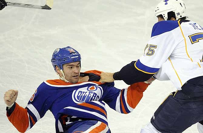St. Louis Blues' Ryan Reaves, right, fights with Edmonton Oilers' Darcy Hordichuk during the first period of an NHL hockey game in Edmonton, Alberta, on Wednesday, Feb. 29, 2012.
