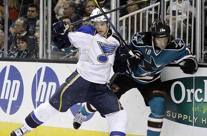 St. Louis Blues center Vladimir Sobotka (17), of the Czech Republic, collides with San Jose Sharks' Dominic Moore during the first period of an NHL hockey game Saturday, March 3, 2012, in San Jose, Calif. 