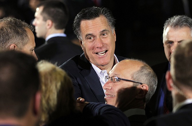 Former Massachusetts Gov. Mitt Romney greets supporters at a campaign rally at Gregory Industries in Canton, Ohio.