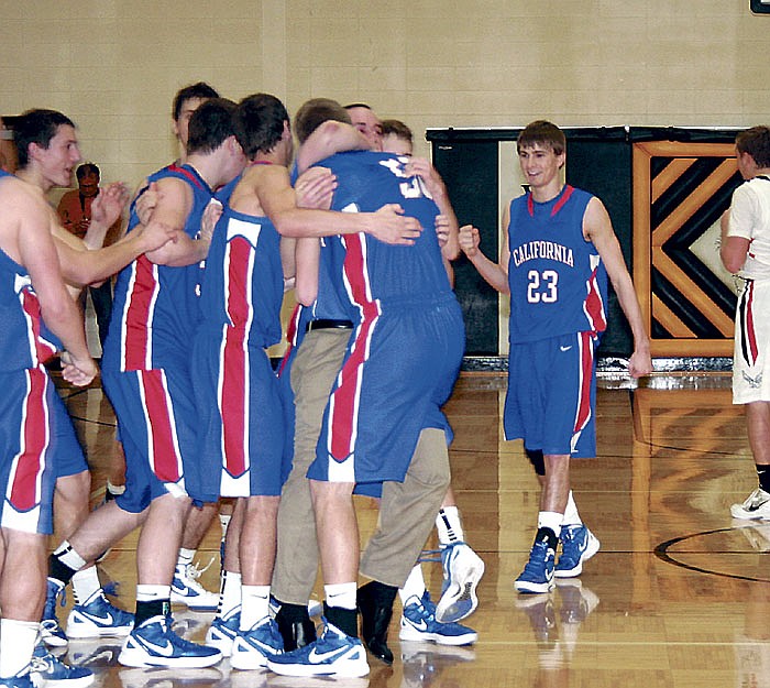 California Head Coach Blair Scanlon and the Pintos celebrate their district championship win Saturday after defeating Eugene 61-55 at the Class 3 District 10 Basketball Tournament at Versailles. This is the first district title the Pintos have won since 1990. California advances to Class 3 Sectionals today (Wednesday) at the Missouri University of Science and Technology at Rolla, where the Pintos will play Blair Oaks at 7:45 p.m.