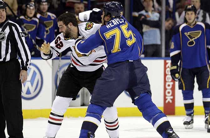 St. Louis Blues' Ryan Reaves (75) lands a punch in a fight with Chicago Blackhawks' Brandon Bollig (52) in the first period of an NHL hockey game, Tuesday, March 6, 2012 in St. Louis.