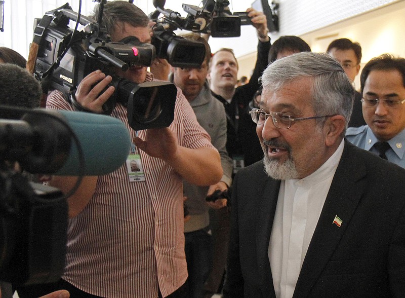 Iran's ambassador to the International Atomic Energy Agency, Ali Asghar Soltanieh, is surrounded by media and security when leaving the IAEA board of governors meeting Tuesday in Vienna. 