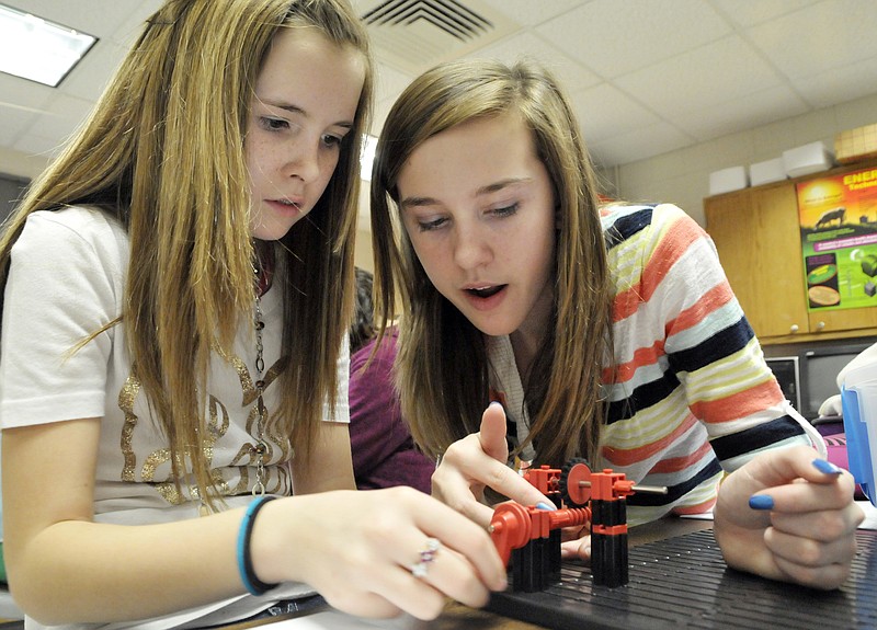 Alexa Struemph, left, and Mackinzey Lux count the revolutions required to turn the gear one full round as the two teamed up to build a mechanism in Garth Haugen's sixth grade class. This is Math and Science Week but Gateway to Technology program is a middle school program in place all year.