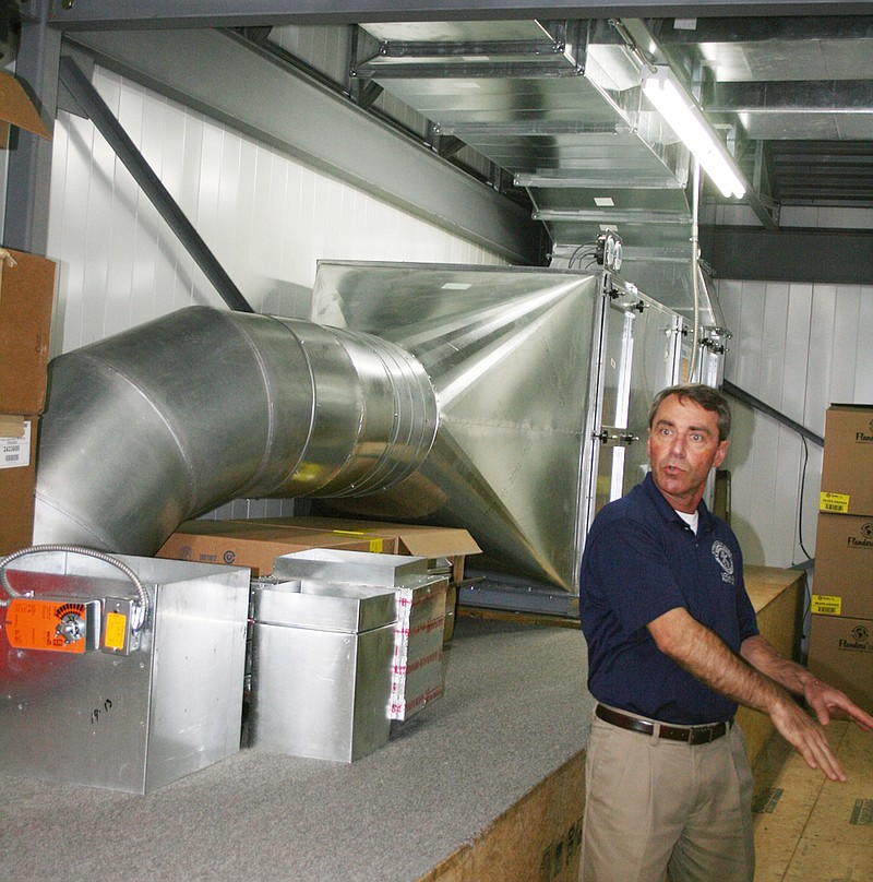 Russ Unger, apprenticeship cooridnator, explains the ventilation process at the training facility of Sheet Metal Workers Local 36 during tours Saturday in Fulton. The ductwork cleans air taken from the welding area and recirculates it throughout the building.