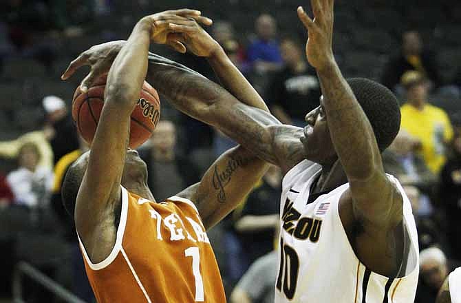 Missouri Tigers forward Ricardo Ratliffe (10) blocks a shot by Texas guard Sheldon McClellan (1) during the second half of an NCAA college basketball game in the Big 12 Basketball Tournament Friday, March 9, 2012, in Kansas City, Mo. Missouri defeated Texas 81-67.