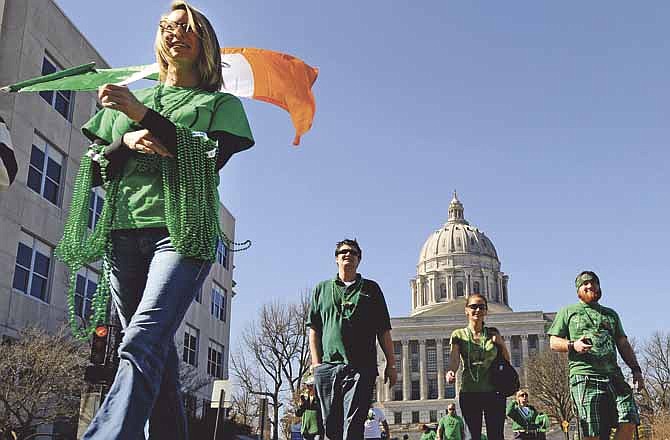
Donning their green and following the Irish flag, dozens of parade participants make their way down Capitol Avenue shortly after leaving Paddy Malone's Irish Pub during the annual St. Patrick's Day parade in Jefferson City on Saturday.