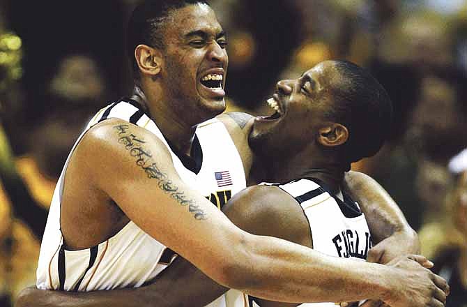Missouri center Steve Moore (32) and guard Kim English (24) celebrate at the end of an NCAA college basketball game in the Big 12 Championship tournament in Kansas City, Mo., Saturday, March 10, 2012. Missouri won the Big 12 Championship defeating Baylor 90-75.