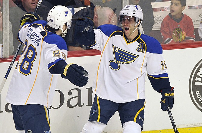 Blues teammates Carlo Colaiacovo (28) and Andy McDonald celebrate after McDonald's goal in Tuesday night's game against the Blackhawks in Chicago.