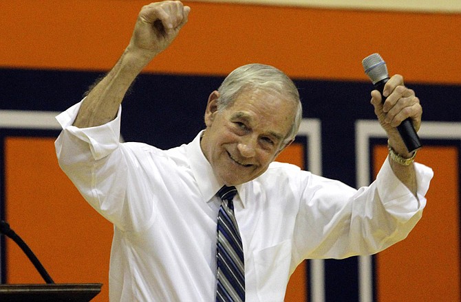 Rep. Ron Paul, R-Texas, celebrates with supporters during a campaign rally Wednesday in Champaign, Ill.