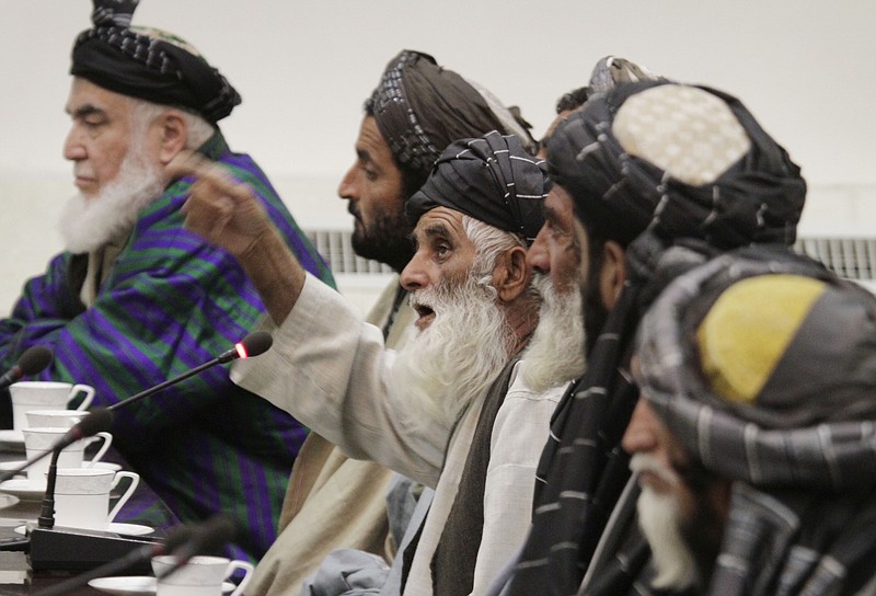 Abdul Samad, center, who lost 11 family members who were shot by a US soldier on Sunday in Panjwai in Kandahar province, talks with Afghan President Hamid Karzai, unseen, at the presidential palace Friday in Kabul, Afghanistan.