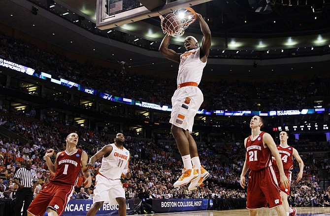 Syracuse forward C.J. Fair dunks in front of a group of Wisconsin defenders during the Orange's 64-63 victory in the Sweet 16 on Thursday in Boston.