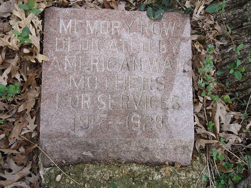 ABOVE: A memorial stone, which was dedicated by the American War Mothers in 1929, has been found in a wooded lot off Country Club Drive.