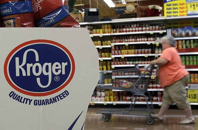 In this Sept. 13, 2010 file photo, a shopper moves through a Kroger Co. supermarket in Newport, Ky. Supermarket chains Kroger Co. and Stop & Shop said Thursday, March 22, 2012 they will join the growing list of store chains that will no longer sell beef that includes an additive with the unappetizing moniker "pink slime."