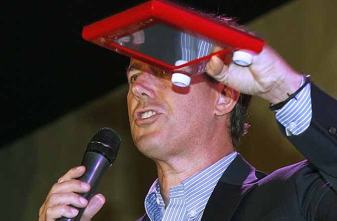 Republican presidential candidate, former Pennsylvania Sen. Rick Santorum holds an Etch A Sketch during a rally in Mandeville, La., Wednesday, March 21, 2012. 