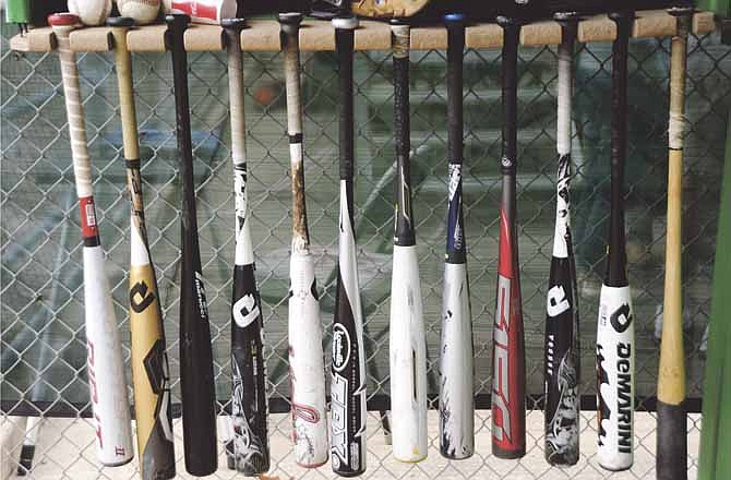 A variety of bats hang in the Jefferson City Jays' dugout during a game last week at Vivion Field.