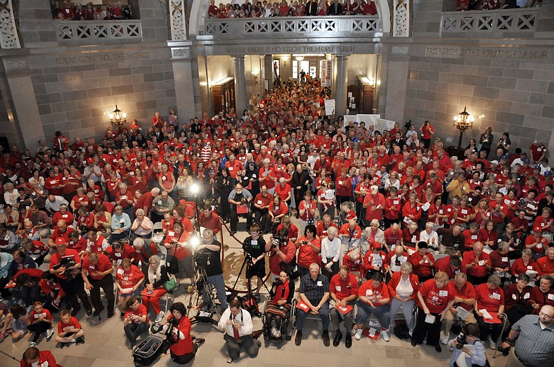 More than an estimated 1,000 people, nearly all of them wearing red, crammed into the Capitol Rotunda on Tuesday in Jefferson City. Their intent was to rally for religious liberty and protest President Barack Obama's policy requiring insurance companies to cover the costs to provide free birth control to women working at religious-affiliated institutions such as hospitals and colleges. Numerous religious leaders addressed the crowd, drawing cheers and loud applause and several "Amens" throughout the rally.