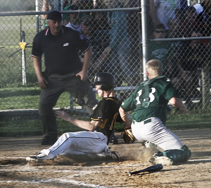 North Callaway junior catcher Jake Kee tags out Fulton sophomore shortstop Dalton Horstmeier at home plate in the top of the fifth inning in the Thunderbirds' 10-0 win over the Hornets on Friday night in Auxvasse. 