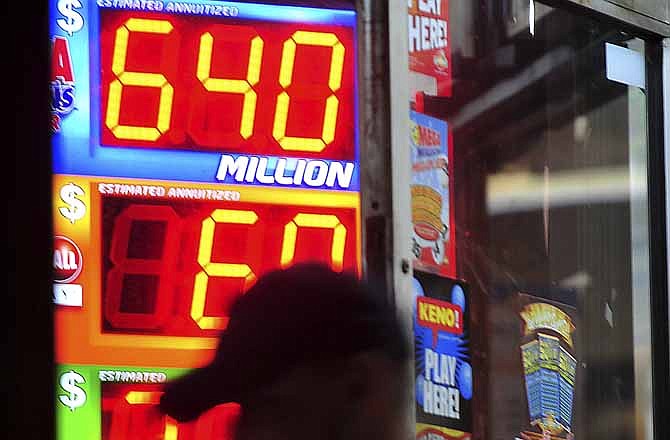 A customer walks out of the Riverside Travel Center in Hilton, Ga., late Friday night after purchasing a lottery ticket for the Mega Millions Lottery which reached an estimated jackpot of $645 million for Friday night's drawing. After the numbers were selected, officials reported a winning ticket was sold in Maryland. (AP Photo/Jay Hare, The Eagle)