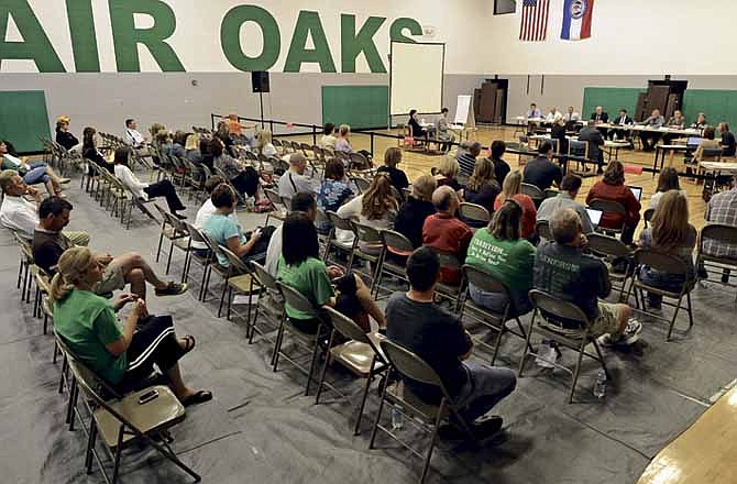 A number of concerned parents, teachers and local residents sit in on Saturday's open hearing in the Blair Oaks Middle School gym regarding the school board's decision not to renew the contract of Blair Oaks Elementary principal Lorie Winslow. 