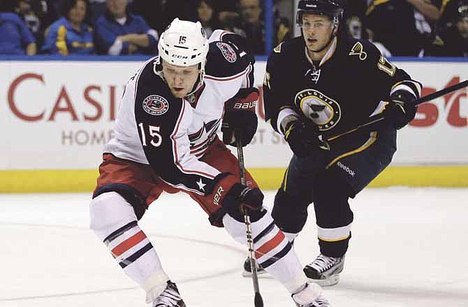 Columbus Blue Jackets' Derek Dorsett (15) handles the puck as St. Louis Blues' Vladimir Sobotka, of the Czech Republic, watches during the first period of an NHL hockey game, Saturday, March 31, 2012, in St. Louis.