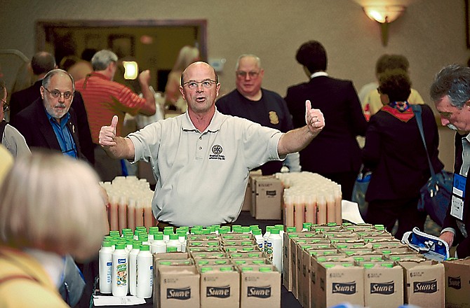 Jefferson City Breakfast Rotarian Tom Quinn directs members of Rotary District 6068 as they assemble 300 well-baby kits to be delivered to Panama.