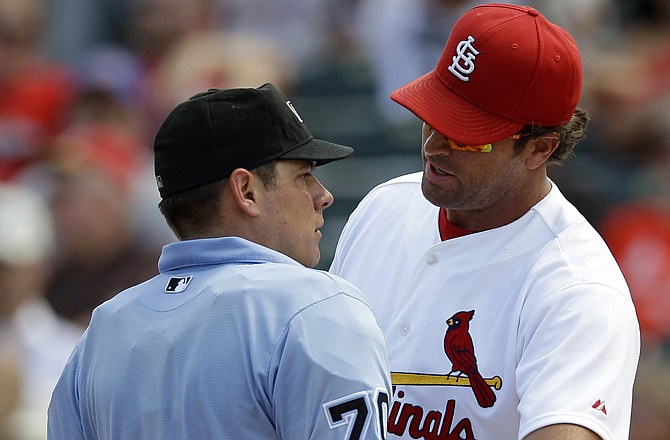 Cardinals manager Mike Matheny protests to umpire D.J. Reyburn after he called Danny Espinosa of the Nationals safe on a slide into home plate in the ninth inning of Sunday's game in Jupiter, Fla.