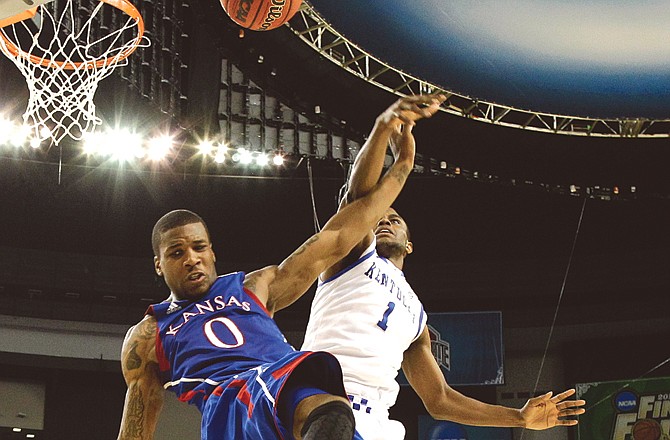 Thomas Robinson of Kansas and Darius Miller of Kentucky battle for the ball Monday night in New Orleans.