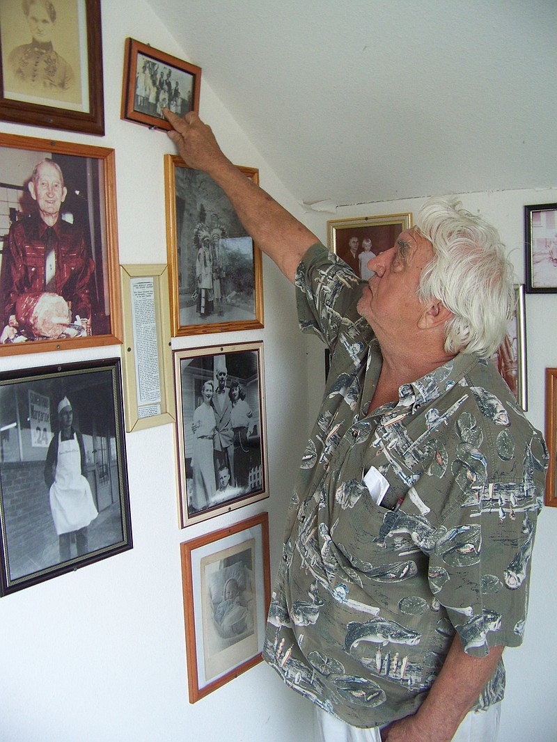 Tom Dawson points out his ancestors in photos adorning Tonanzios' walls. Dawson comes from a long line of missionaries and restaurateurs in Callaway County.