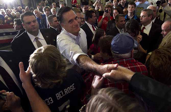 Republican presidential candidate, former Massachusetts Gov. Mitt Romney greets people in a crowd during a campaign event at a metal working shop, in Broomall, Penn., Wednesday, April 4, 2012.