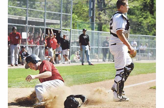 Torre Thompson of the Jays slides in to home plate safely behind Rockwood-Summit catcher Jack Quick on Friday afternoon at the Capital City Invitational.